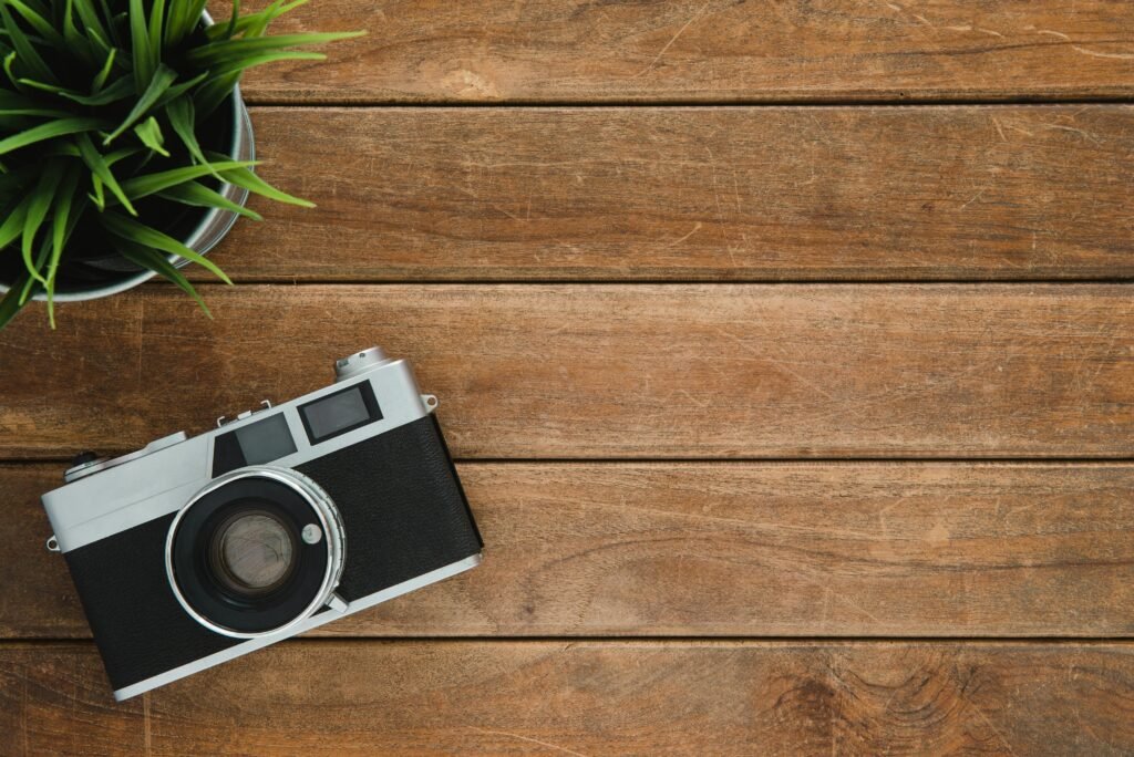 Vintage camera on a wooden table, representing photo editing inspiration.